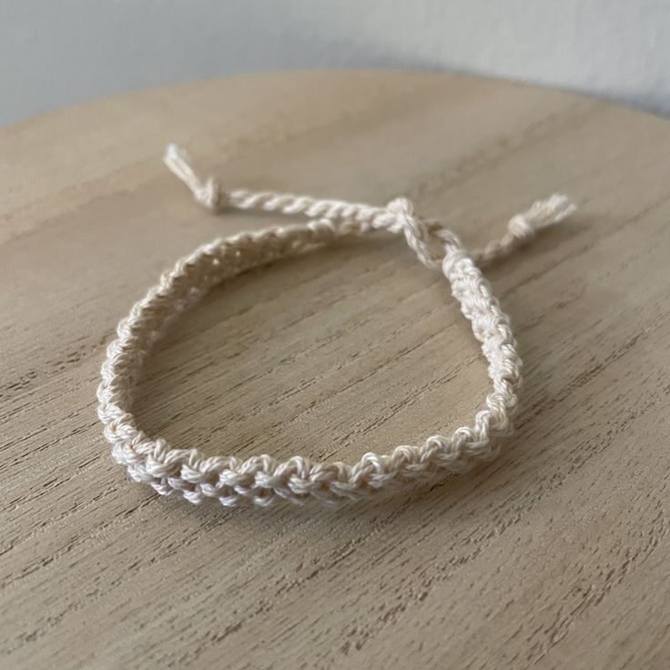 a white bracelet on top of a wooden table