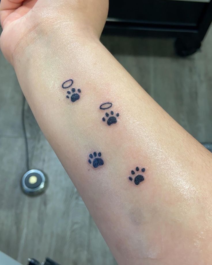 a person's arm with three paw prints on it