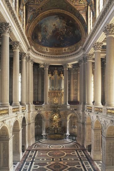 the interior of a church with columns and paintings on the walls, along with an ornately decorated ceiling