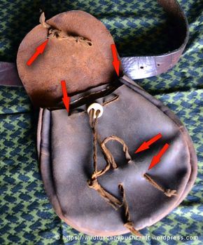 an old baseball mitt with red arrows pointing to the hole where it was placed