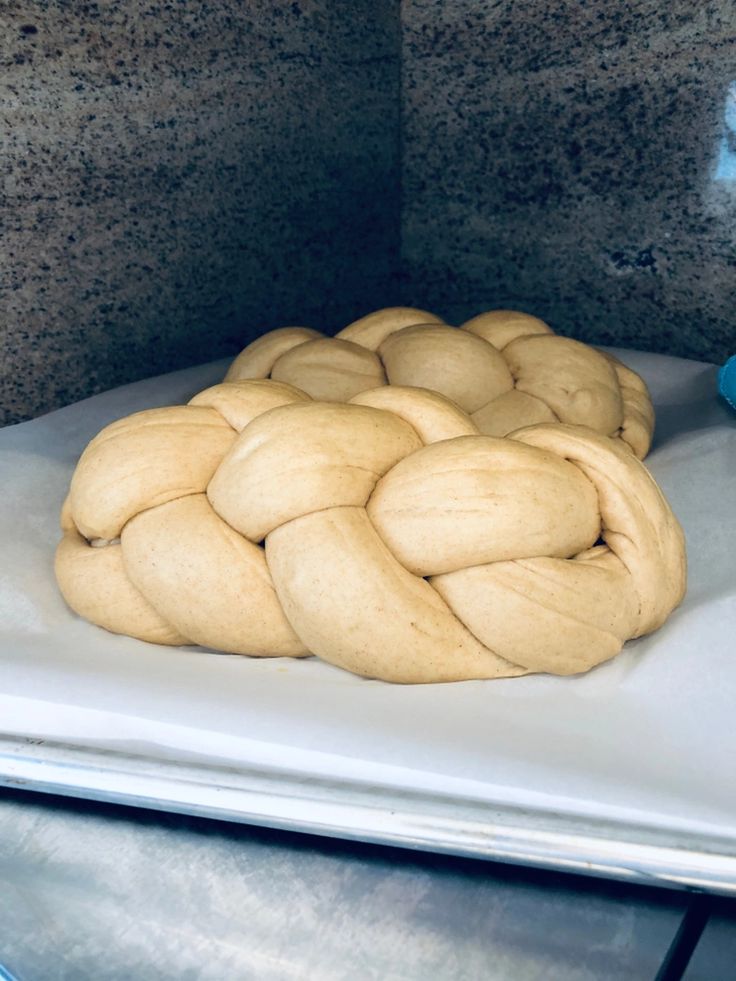 a bunch of uncooked bread sitting on top of a counter