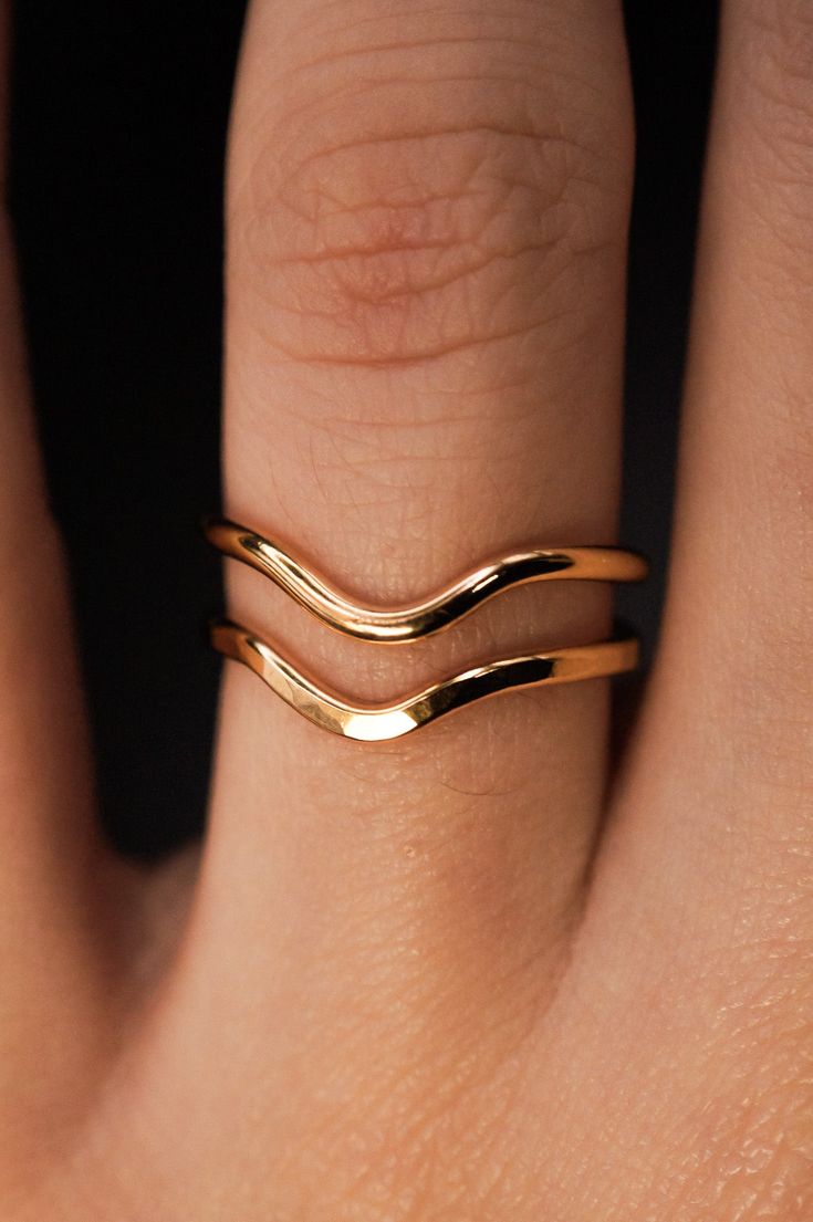 A curved arc stacking ring made from 14K Gold Fill Metal. After countless requests and some fine tuning, we finally perfected this ring shape! The Teardrop Ring stacks with all of our rings beautifully. It adds dimension to any stacking rings you wear daily but it also makes the perfect, low-key wedding band! The bend in the Teardrop Ring curves to hug a set stone beautifully if you are looking for a complimentary piece for your existing engagement ring. This listing is for ONE SINGLE RING.Made from 14K GOLD FILL metal.Available in a SMOOTH or HAMMERED texture. The smooth finish is fully round metal.Each ring measures approximately 1.75 mm in width. We recommend stacking the Teardrop Ring with the Pebble Ring, one of our favorite dimensional pieces inspired by precious stone rings but made Low Key Wedding, Pebble Ring, Ring Stacks, Curve Ring, Precious Stones Rings, Teardrop Ring, Single Ring, Ring Shapes, Stacking Ring