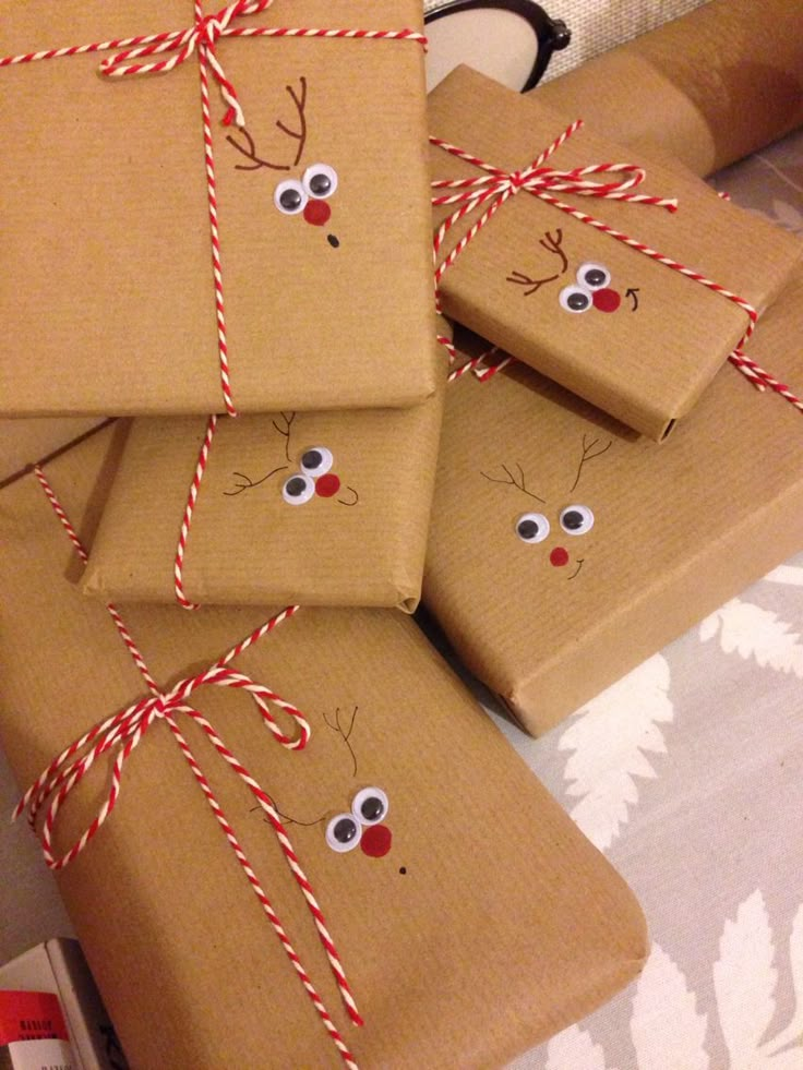 four wrapped presents with reindeer faces on them