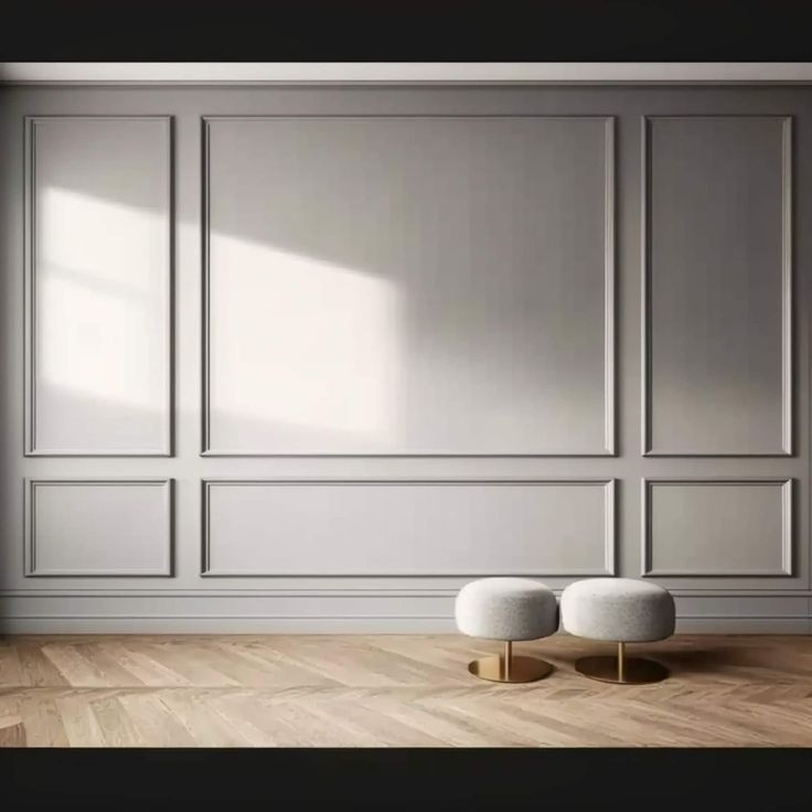 an empty room with two stools in front of the wall and wooden flooring