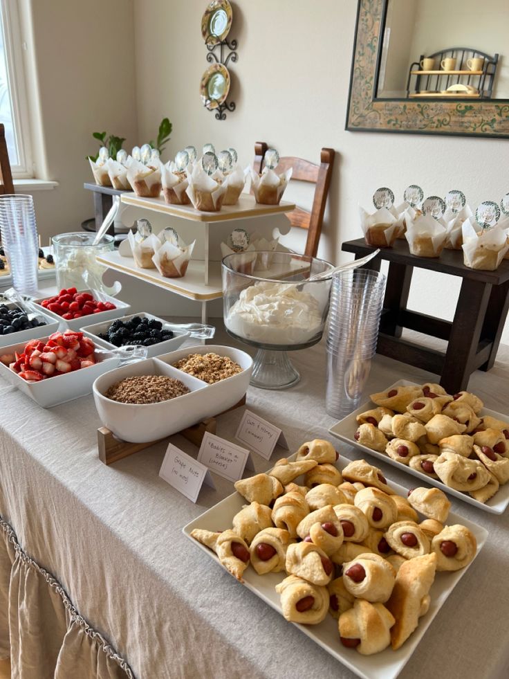 a table topped with lots of desserts and pastries on top of it's sides