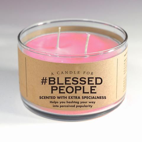 a pink candle that is sitting on a white surface with the words, blessed people printed on it