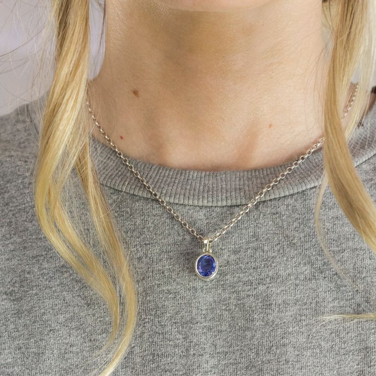 A delicate balance of rich blue and violet, this gem has fine crystal inclusions and an exquisite luster. Wearing this deep blue-hued beauty will add an elegant touch to any outfit. Known as the ‘stone of magic’ this faceted Tanzanite necklace brings its wearer the confidence to turn ideas into reality. Bringing the “will” to start and enhances from beginning to the end. This stone is also great for Communication and Protection. Stone Origin: ﻿Tanzania Measures Approximately: 10 x 8 mm Materials Tanzanite Gemstone Round Pendant Jewelry, Tanzanite Gemstone Round Pendant, Blue Kyanite Gemstone Necklace, Elegant Blue Tanzanite Gemstones, Blue Kyanite Necklace For Gift, Fine Tanzanite Oval Pendant Jewelry, Blue Amethyst Pendant Necklaces, Blue Amethyst Pendant Necklace, Oval Faceted Blue Jewelry