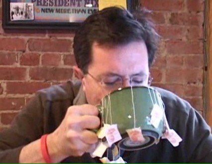 a man drinking out of a coffee cup with money sticking out of his mouth and eyes closed