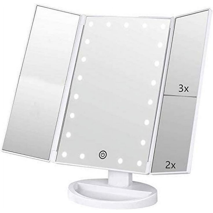 a white lighted vanity mirror on top of a table