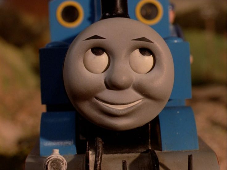 thomas the tank engine is smiling and looking at the camera with his eyes wide open