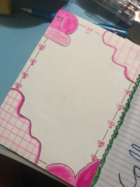 an open notebook with pink and green designs on it