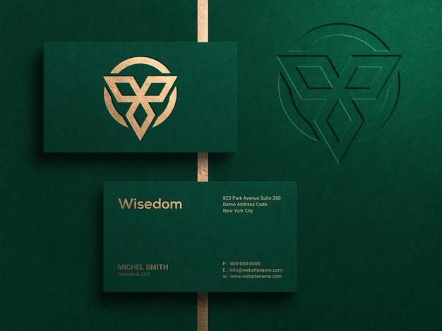 two green business cards with gold foil on the front and back, sitting next to each other