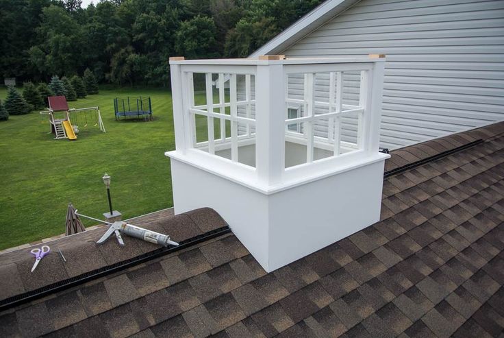 a white window on the roof of a house