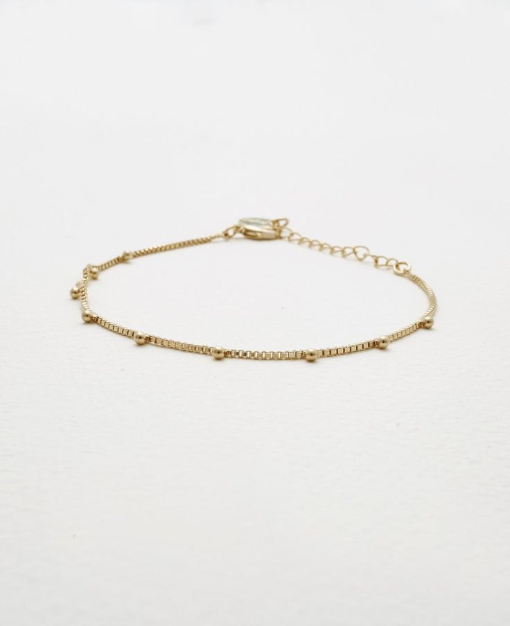 Slim and elegant bracelets never fail to impress us and we know every woman finds tons of uses for these in her collection. Meet all your dainty elegance goals with our Emery bracelet. The delicate design exudes tons of charm and femininity and will fit effortlessly into your hectic weekday dress-ups too.- Brass with Polyurethane Coating- Adjustable length of 7" to 9"- Available in Gold and Silver Adjustable Gold Bracelet With Satellite Chain, Delicate Chain Bracelet With Extender, Dainty Metal Bangle Charm Bracelet, Delicate Adjustable Charm Bracelet, Delicate Gold Bracelet With Satellite Chain, Delicate Adjustable Jewelry With Bracelet Strap, Trendy Adjustable Charm Bracelet With Delicate Chain, Adjustable Delicate Chain Beaded Bracelets, Elegant Metal Anklet With Adjustable Chain