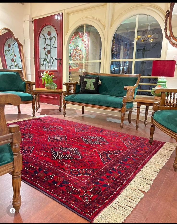 a living room filled with lots of furniture and rug on top of a hard wood floor