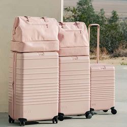 three pink suitcases sitting next to each other