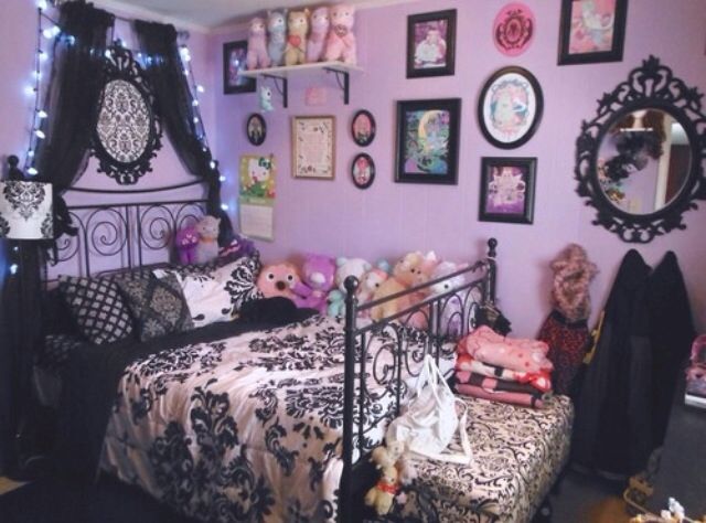 a bedroom decorated in black and pink with pictures on the wall above the bed, teddy bears sitting at the foot of the bed