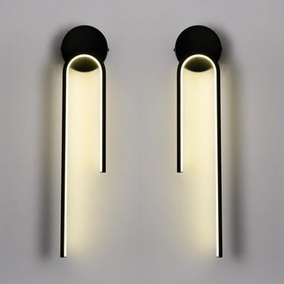 two lights that are on the wall next to each other, one is black and white