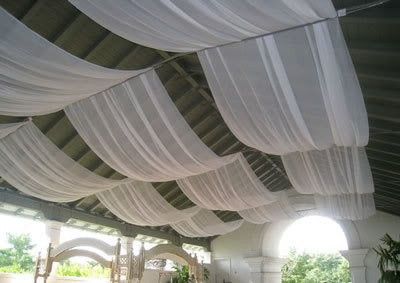 an indoor covered patio with white drapes