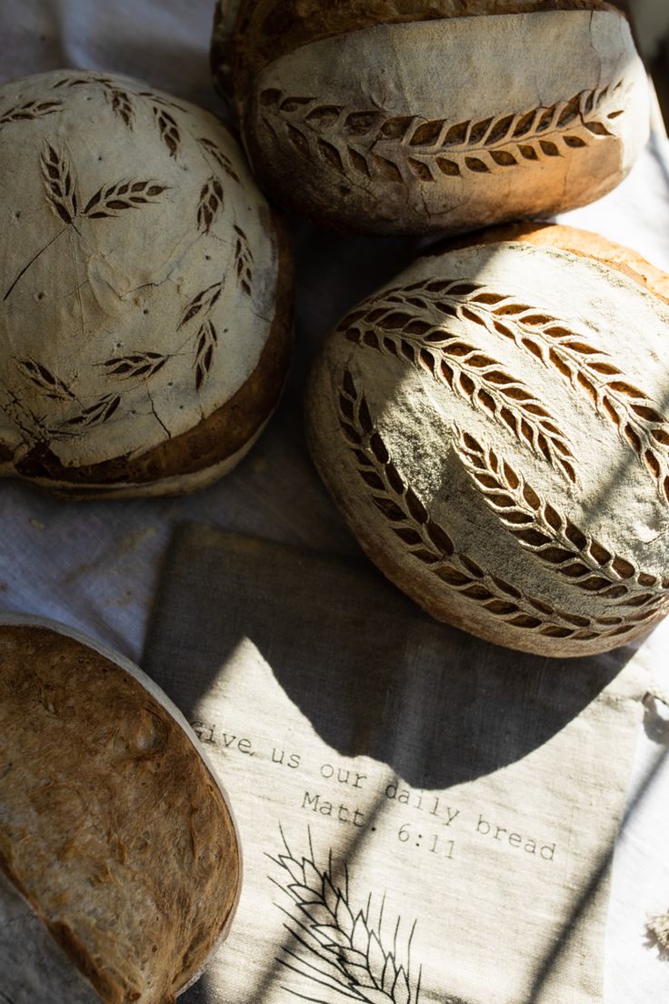 three breads sitting on top of a table next to each other