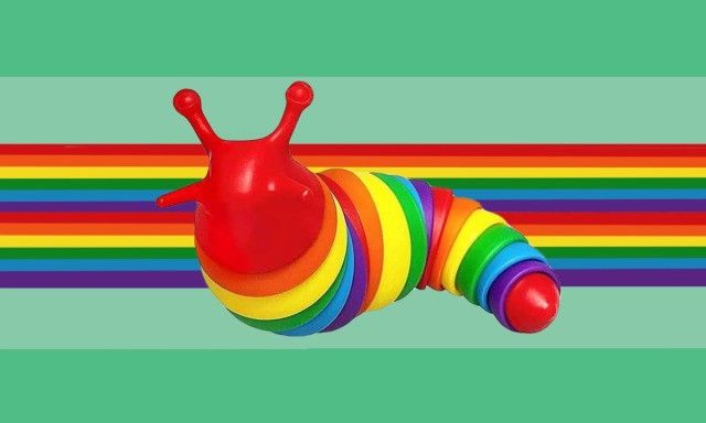 a very cute colorful toy with a big snail on it's back end and rainbow stripes in the background