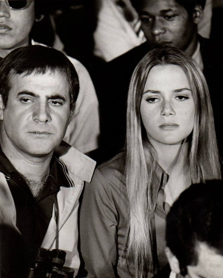 black and white photograph of people sitting next to each other at an event or gathering