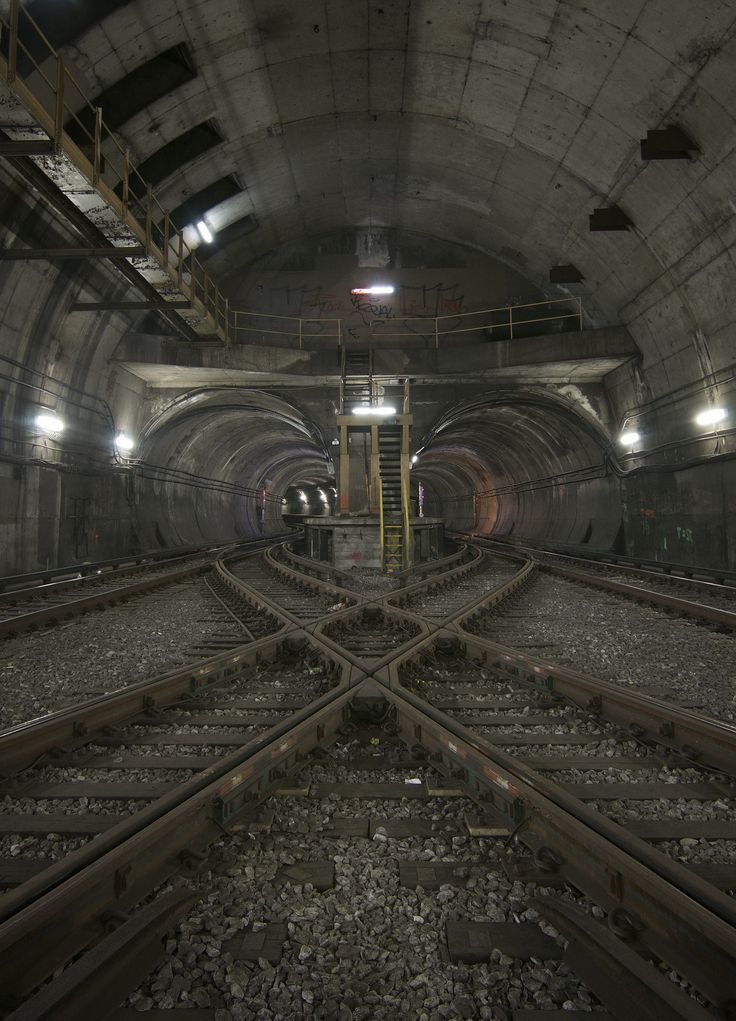 the inside of a train tunnel with tracks