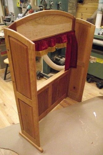 an open wooden door in the middle of a workbench