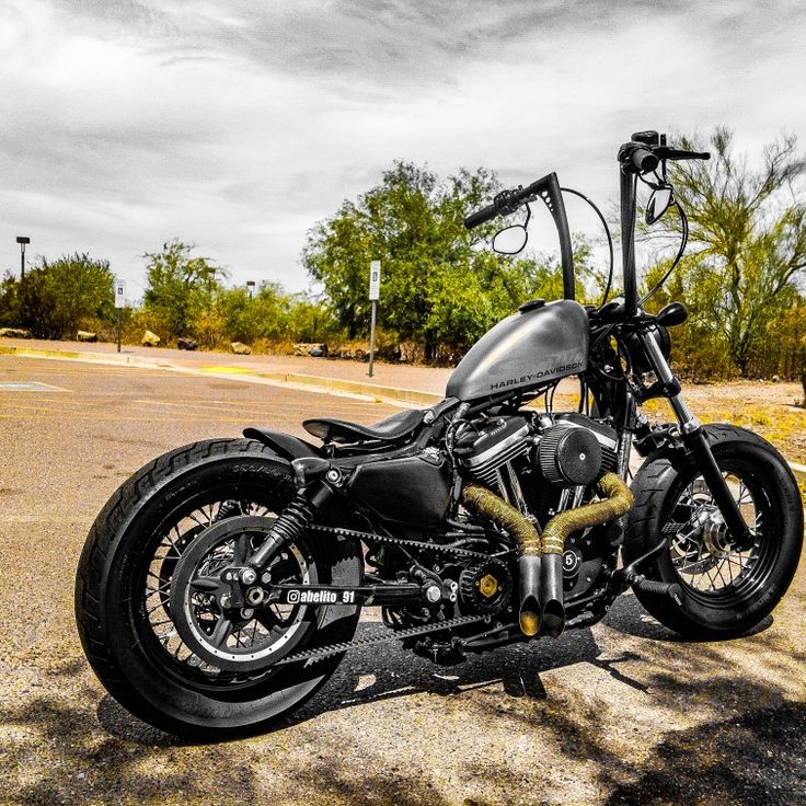 a black motorcycle parked in the middle of a parking lot