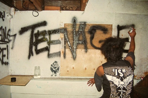 a person spray painting graffiti on the wall