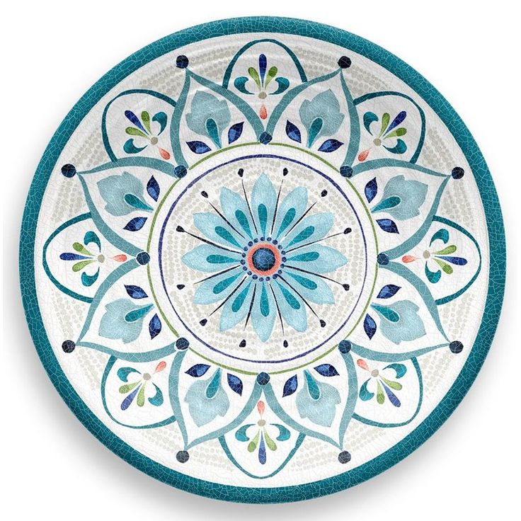 a blue and white plate with an intricate design on the front, sitting on a white surface