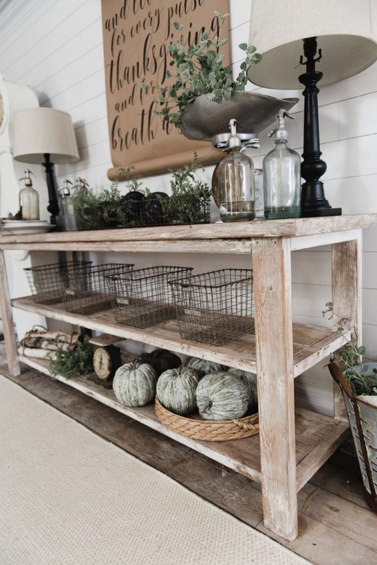 a wooden shelf with baskets and pumpkins on it