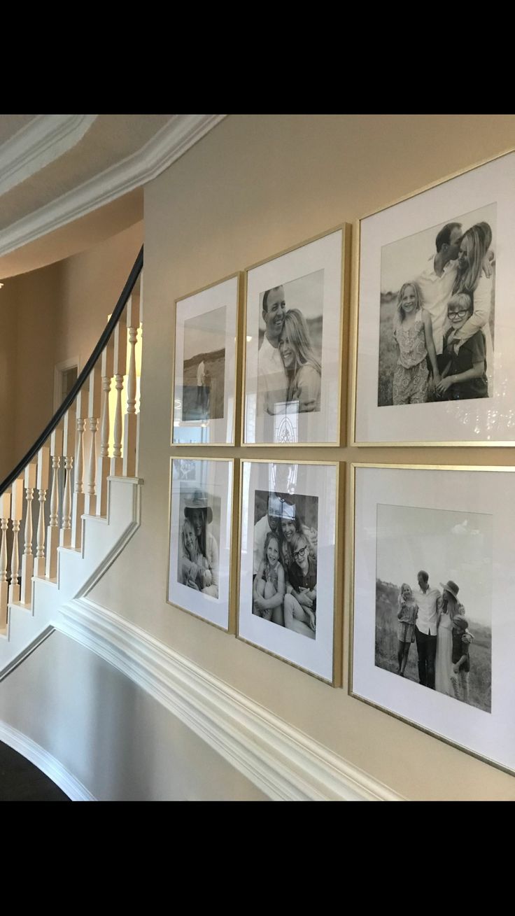 a staircase with pictures hanging on the wall