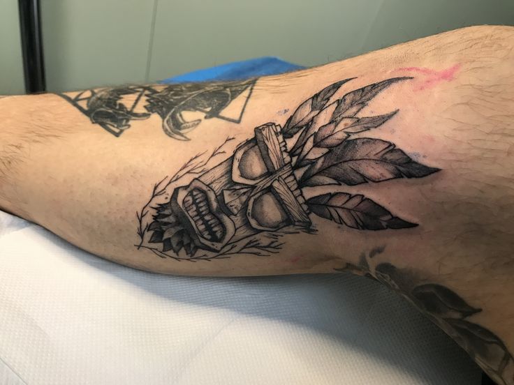 a man's arm with a tattoo on it and an arrow in the center