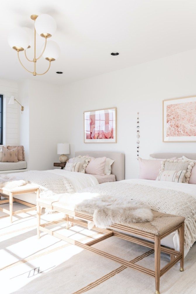 a bedroom with two beds and a chandelier