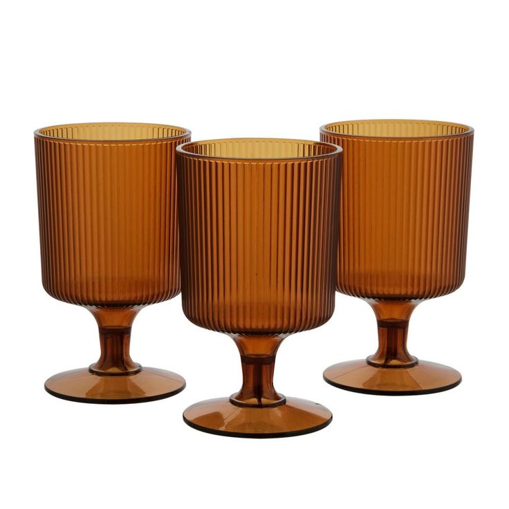 three brown glass goblets sitting next to each other