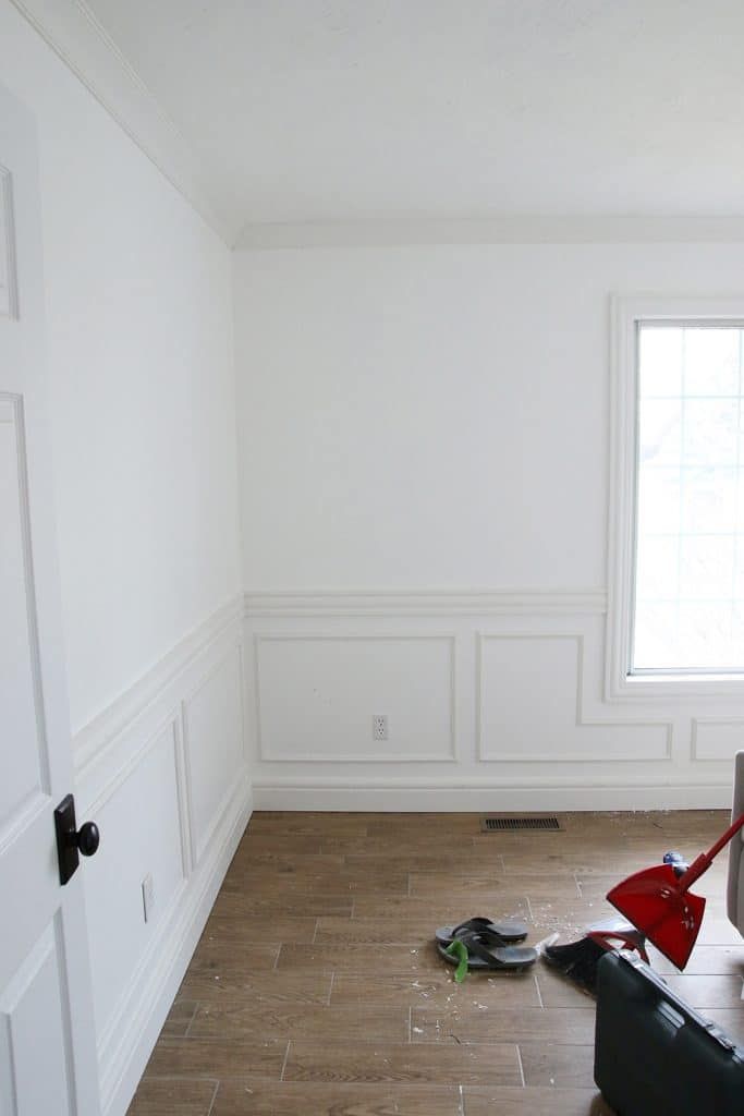 an empty room with hard wood flooring and white paint on the walls is being worked on