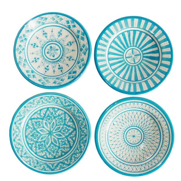 four blue and white plates sitting on top of each other in the shape of circles