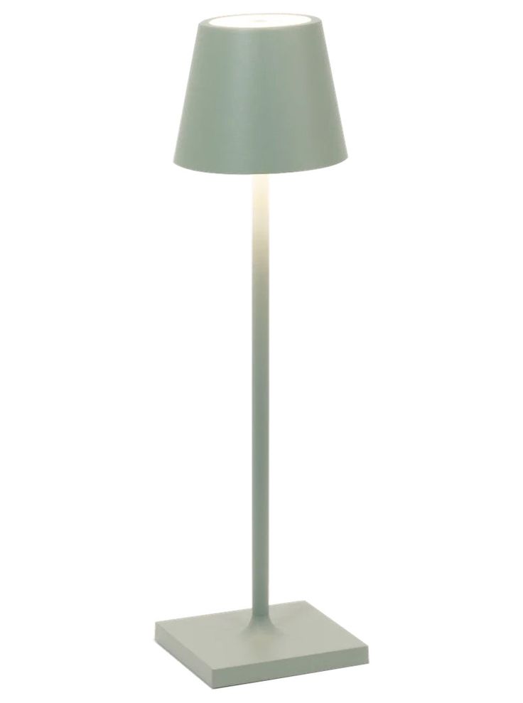 a lamp that is on top of a white stand with a blue shade over it