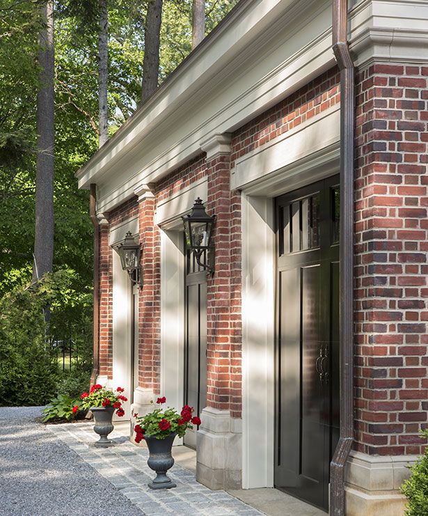 a brick building with potted flowers on the outside