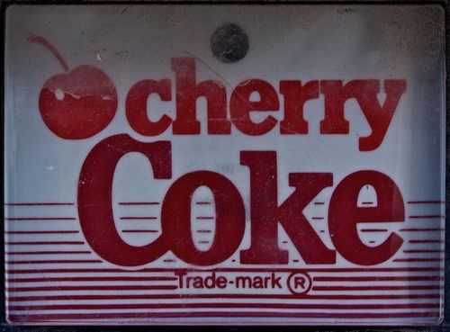 a sign that says cherry coke trade mark