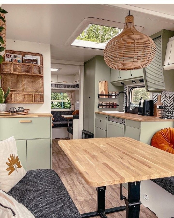 a kitchen and dining area in a small home with wood flooring, green walls and ceiling