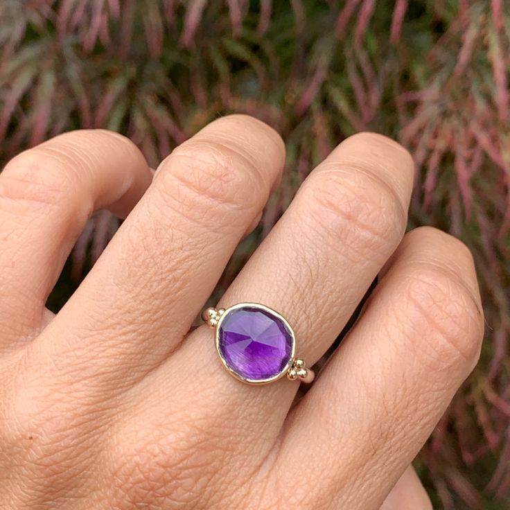 One of the most vibrant Amethysts we have come across, this rosecut gem is set in 14k yellow gold with gold accent beads, and a sterling silver freeform band. Approx stone size: 12mm x 10mm Approx ct weight: 3.2cts Mohs hardness: 8 This one of a kind piece is handmade with love in Emily's Hudson Valley studio. If you have questions about sizing, shipping or need help deciding on your perfect piece please reach out to us! Fine Jewelry Amethyst With Bezel Setting, Sterling Silver Rings With Gemstone Accents For Gift, Heirloom Style Adjustable Sterling Silver Jewelry, Sterling Silver Yellow Gold Gemstone Jewelry, Sterling Silver Wedding Birthstone Gemstones, White Gold Jewelry With Gemstone Accents For Promise Ring, White Gold Promise Ring With Gemstone Accents, Wedding Birthstone Gemstones In Sterling Silver, Fine Jewelry Faceted Gemstones For Gift