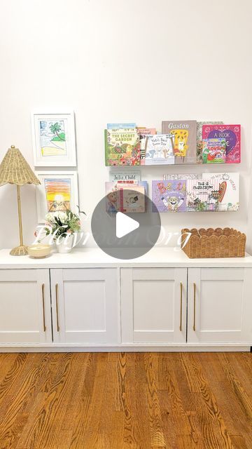 a room with white cabinets and pictures on the wall