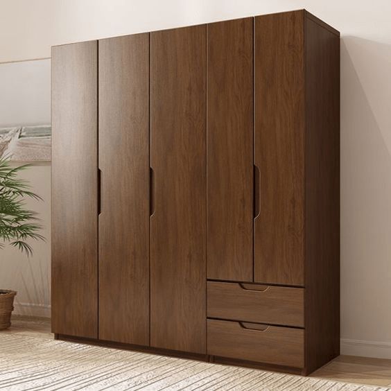 a large wooden cabinet sitting in a room next to a potted plant on the floor