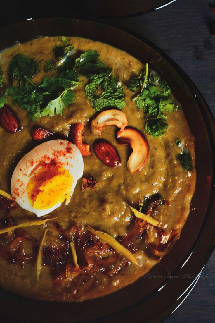 a bowl filled with soup and vegetables on top of a table