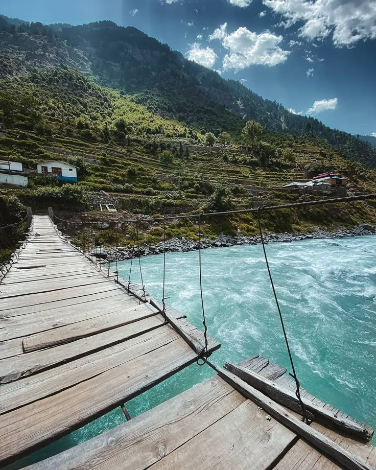 a wooden bridge that is over some water