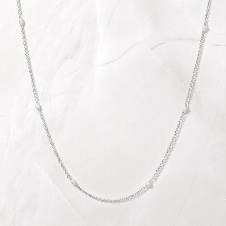 An elegant and timeless necklace made of FRESHWATER Pearls! This necklace is perfect for multiple occasions from weddings & bridal to casual beach days. Can be worn alone or layered with more pieces for an elevated look. Pearls are dispersed amongst a beautiful gold or silver rope chain. Made of 925 Sterling Silver THICK plating of 14k Gold or Rhodium. Made with Freshwater Pearls 16" + 3" Ext Chain Nickel-free & Hypoallergenic Lobster Clasp Closure Delicate Single Strand Bridal Necklace, White Sterling Silver Necklace With Satellite Chain, Classic White Beaded Chain Necklace, Elegant White Beaded Chain Layered Necklace, White Elegant Layered Necklace For Everyday, Elegant White Layered Necklace For Everyday, Elegant Everyday White Layered Necklace, Silver Beaded Chain Necklace For Wedding, Wedding Silver Beaded Chain Necklace