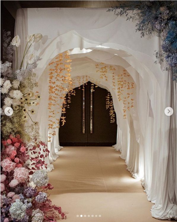 an archway is decorated with flowers and greenery for a wedding or special event venue