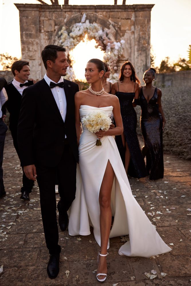 the bride and groom are walking down the aisle at an outdoor wedding in tuxedo, mexico